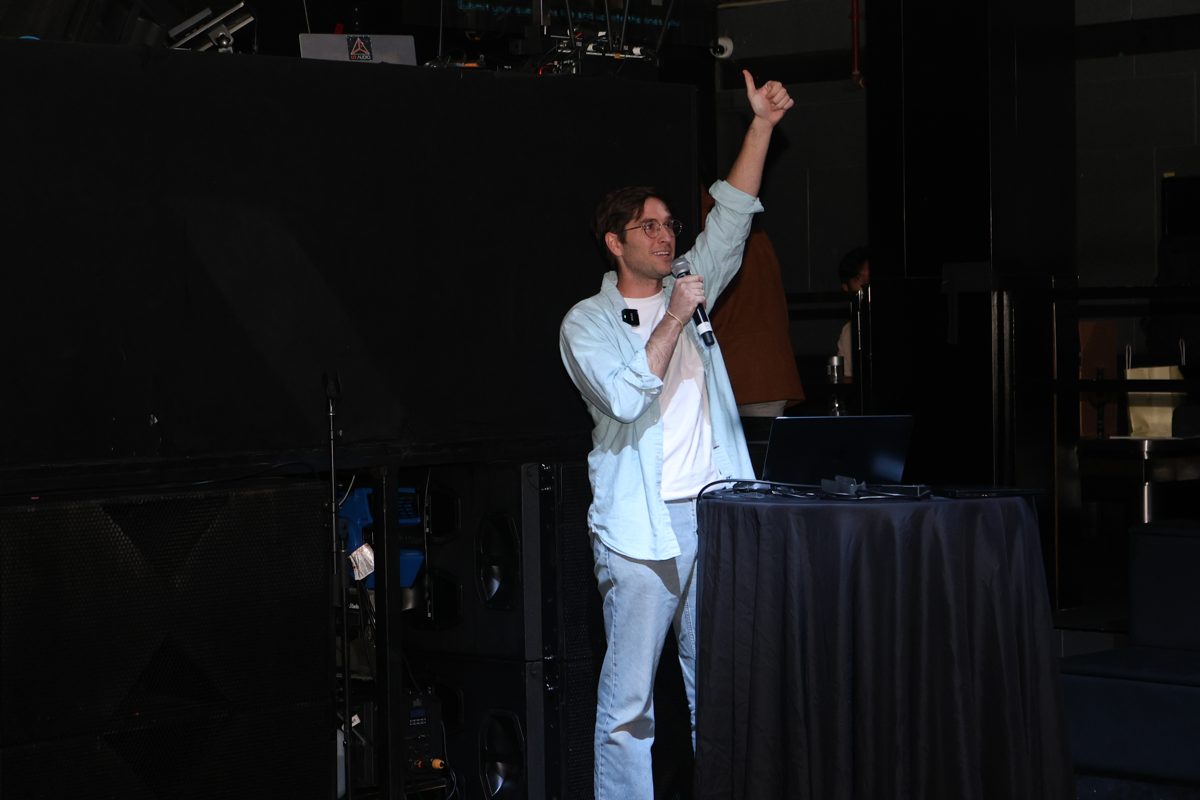 Speaker with arm raised mid-talk