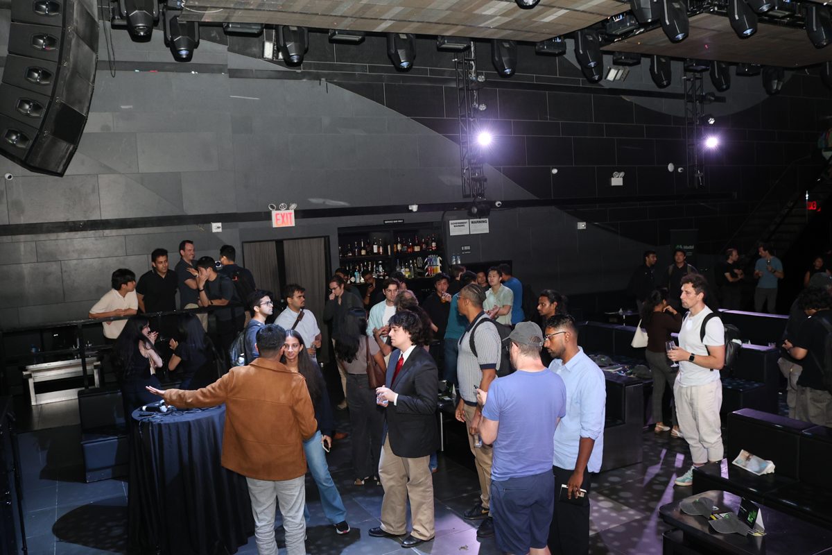 Attendees networking near the stage
